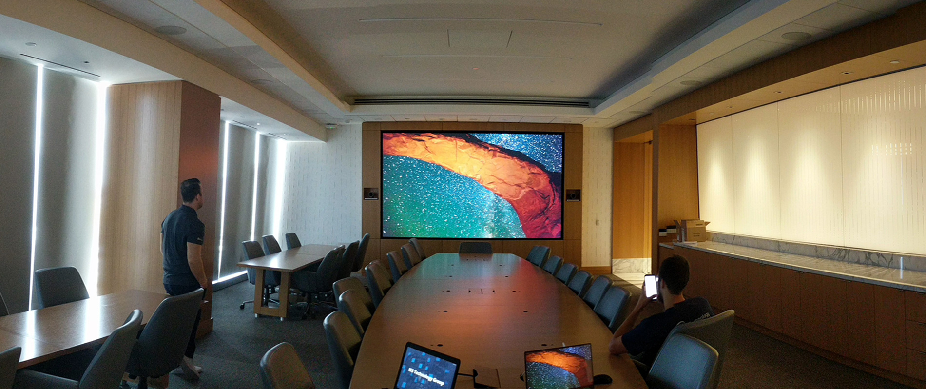 conference-room-with-large-screen-and-monitors-on-table