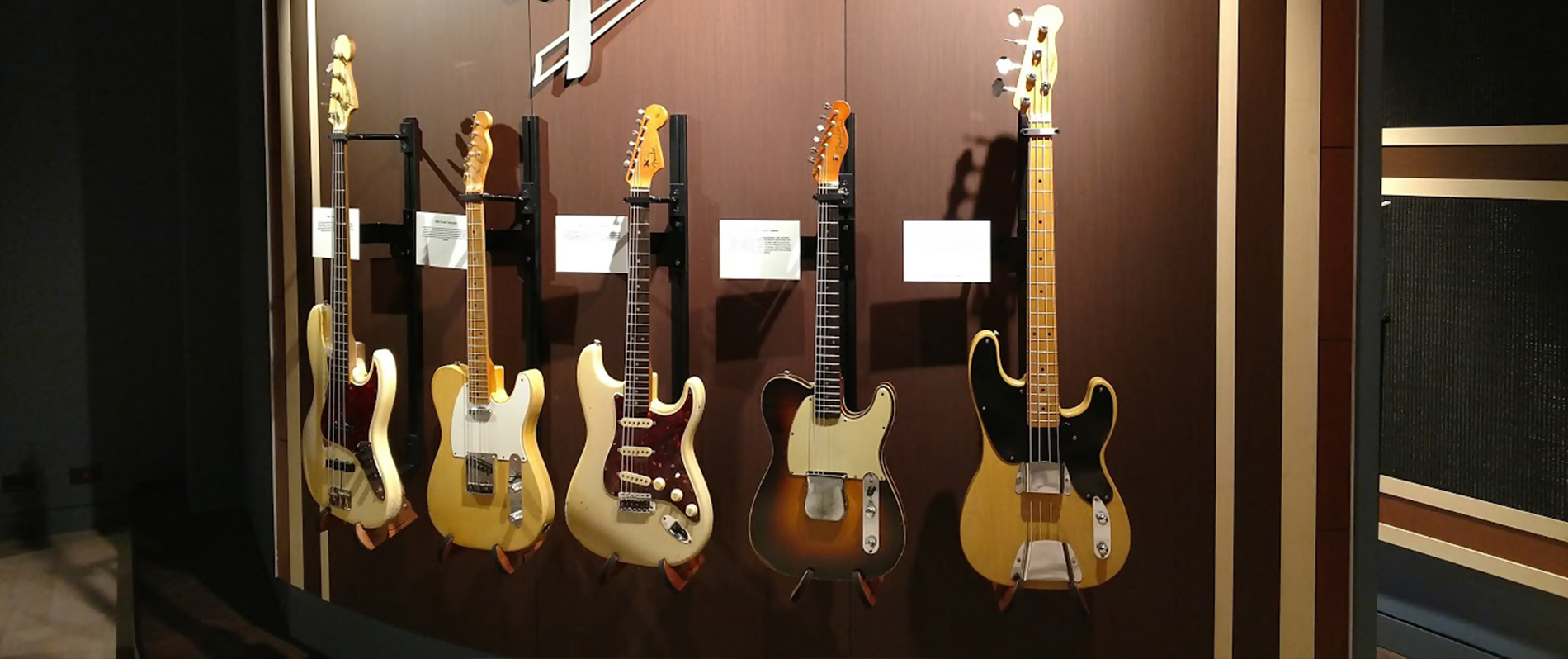 five-guitars-mounted-to-wall