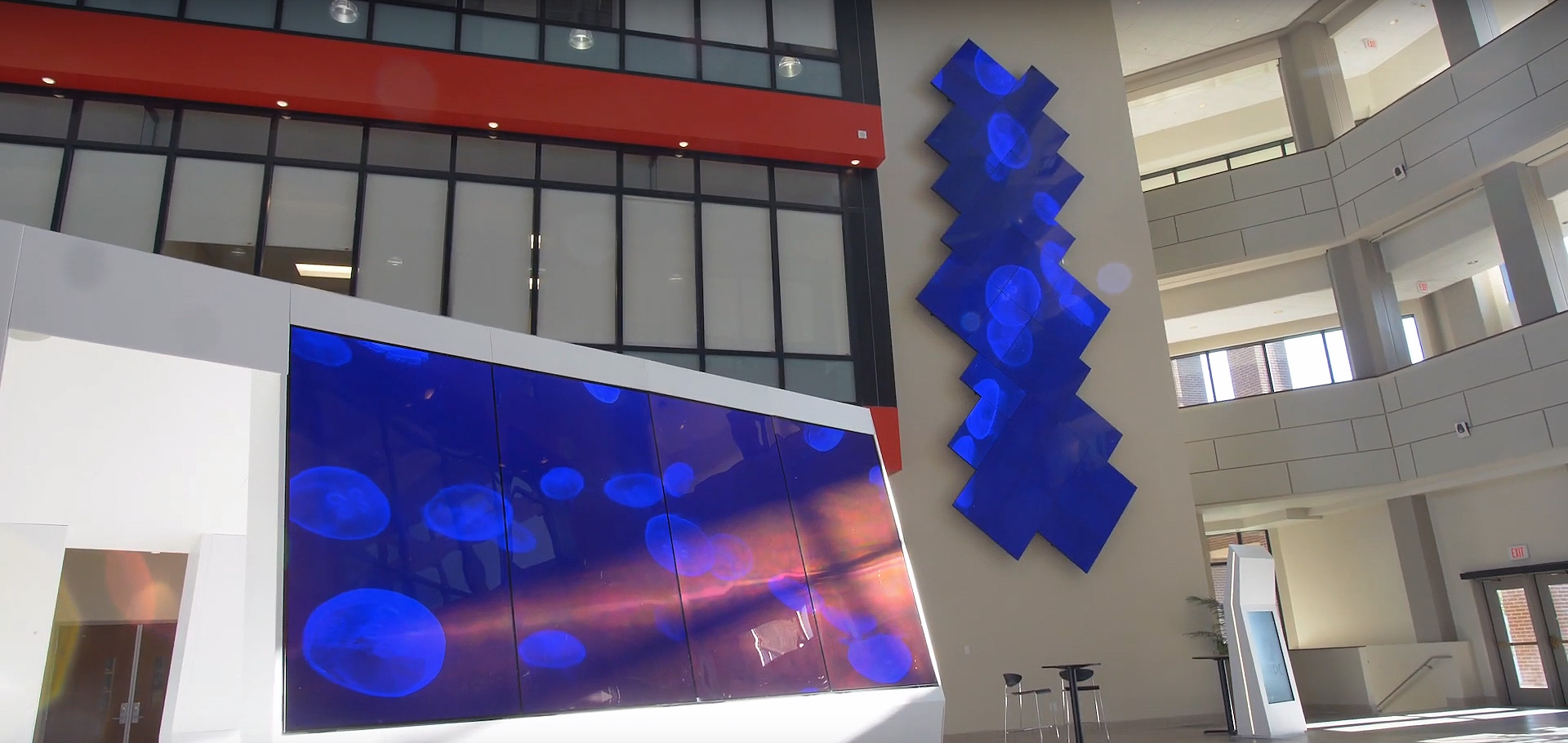 large-lobby-corporate-building-with-large-visual-screens-climbing-wall