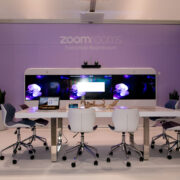 a conference room with a purple wall and white chairs