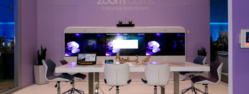 a conference room with a purple wall and white chairs