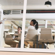 A group of people going over a presentation inside a corporate training room.