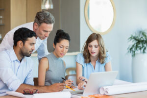 people looking at a laptop and having a discussion