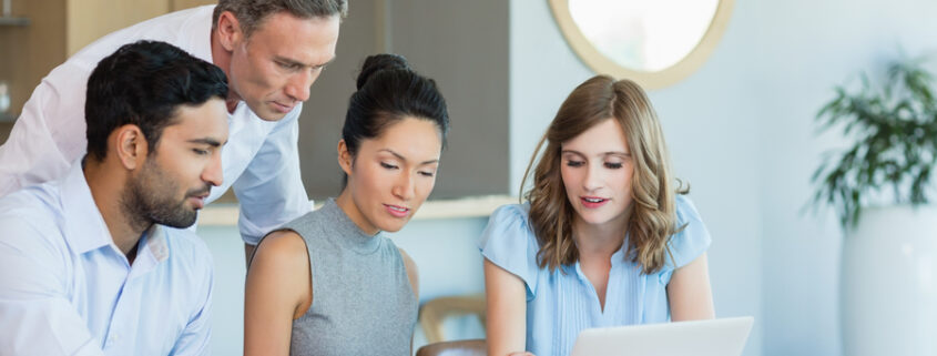 people looking at a laptop and having a discussion