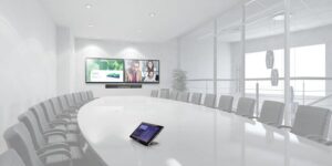 A large conference room with two video displays.