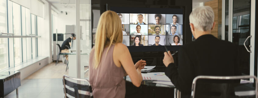 A collaboration space uses a large display to connect with remote workers.