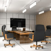 an empty conference room with black swivel chairs  
