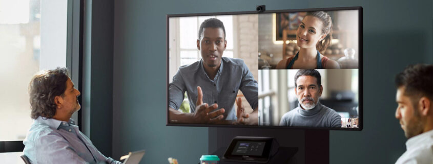 Group of people in a conference room taking part in a video call with Teams Rooms technology.