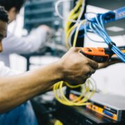 A technician giving maintenance to networking equipment.