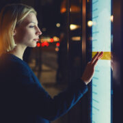 A woman interacting with a touch video wall.