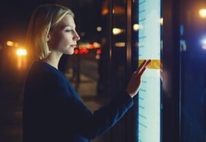 A woman interacting with a touch video wall.