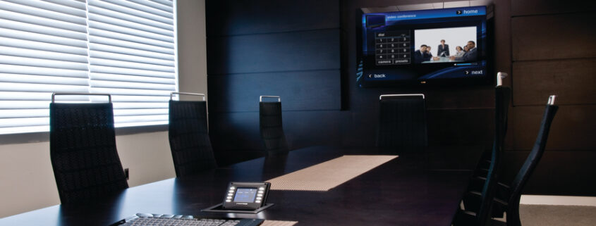 Conference room with display and Crestron control.
