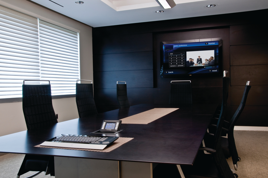 Conference room with display and Crestron control.