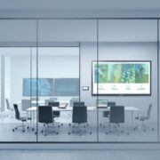 A comprehensive conference room featuring Crestron solutions seen through windows.