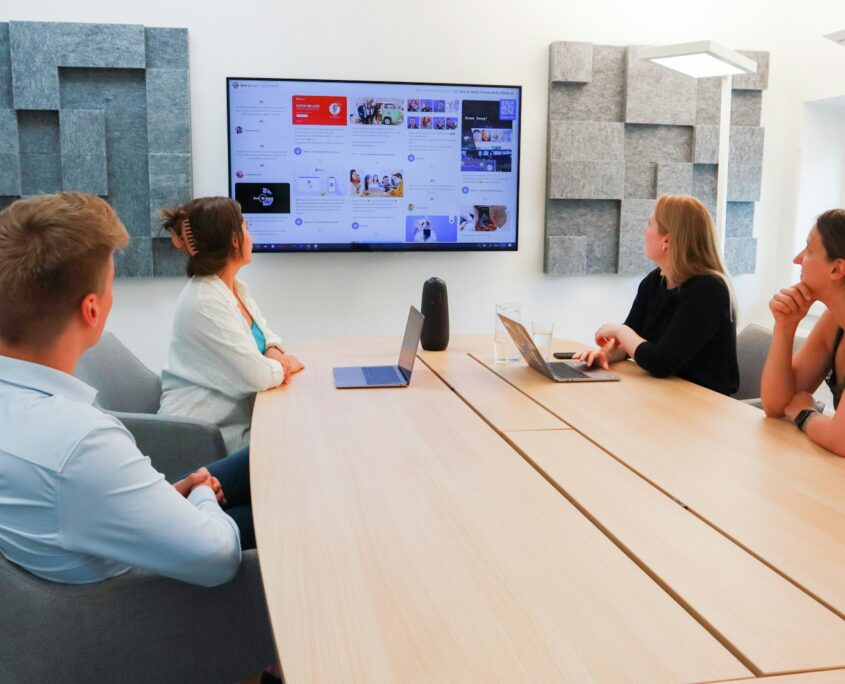 a group of people sitting around a conference table