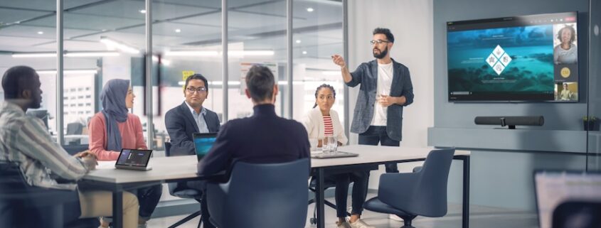 People in a conference room using Crestron technology.